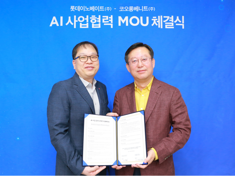 Two men are standing with papers in front of a blue background.